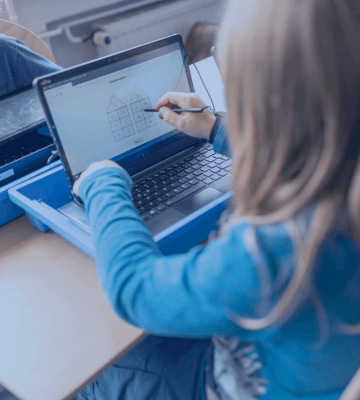 A young student working on a laptop