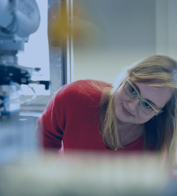 A student examining a technical experiment in a workshop