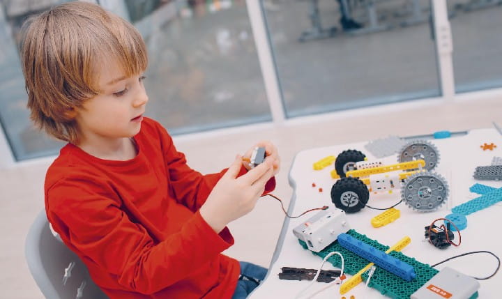 A kid working on a technical Lego project